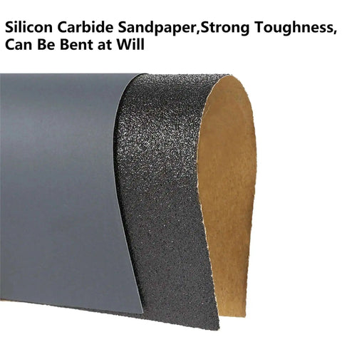 Close-up of silicon carbide sandpaper showing flexibility, part of Assorted Grit Sandpaper Sheets Kit 100 Pack 80 To 5000 Wet And Dry Sanding.