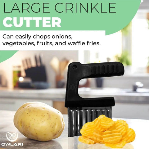 Large crinkle cutter with black handle next to a potato and crinkle-cut fries on a kitchen counter