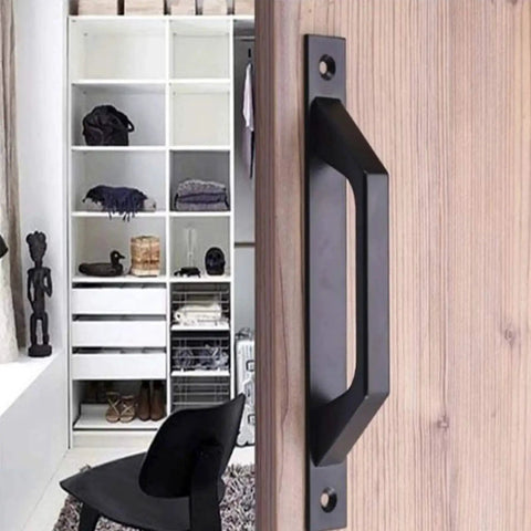 Four Piece Carbon Steel Sliding Barn Door Handle Set In Matte Black Finish installed on wood door, modern interior background