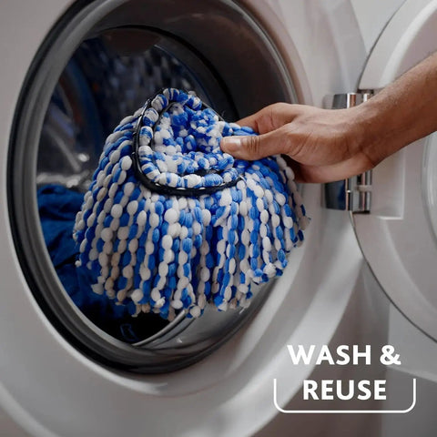RinseClean Spin Mop And Bucket System For Clean Water Mopping Lets You Clean With Clean Water From Start To Finish Removes 99 Percent Of Bacteria With Just Water Built In Foot Pedal For Hands Free Wringer And Easy Rinse mop head being placed into washing machine for cleaning