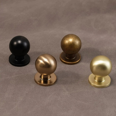 Antique Brass Cabinet Knobs 30 Pack Set For Vintage Drawer Pulls showcasing different finishes on a textured surface.