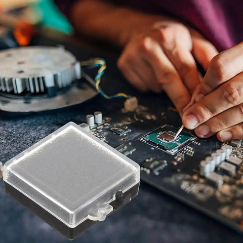 Anti Static Chip Case With Transparent Lid And Black Base Compact Electronics Parts Organizer Box For Safe Storage And Static Shielding Of Small Components 1.57 X 1.38 X 0.59 Inches next to a circuit board with hands working.