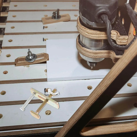 Engraving Machine Clamps For Woodworking Heavy Duty Hold Down Clamps Two Sets 80mm Aluminum Bow Plate Router Workholding Fixtures For CNC Router Table Pro Grade Kit shown in use on a CNC router table, securing a wooden panel.