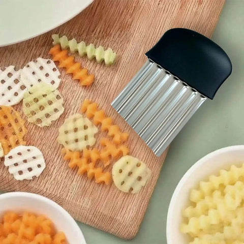 Stainless Steel Crinkle Cutter Wavy Fries Slicer And Vegetable Chopper 2 Pack Black Heavy Duty Blade on cutting board with sliced vegetables