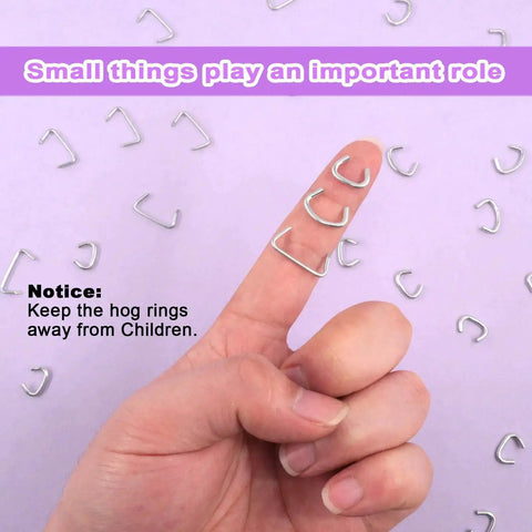 Close-up view of finger holding 360 Piece Galvanized Hog Ring Kit With Angled Pliers For Upholstery Includes Three Quarter Inch, One Half Inch, And Three Eighths Inch Rings Pro DIY Installation Kit For Bungee Cords And Cushions on lavender background, showing ring size and details.