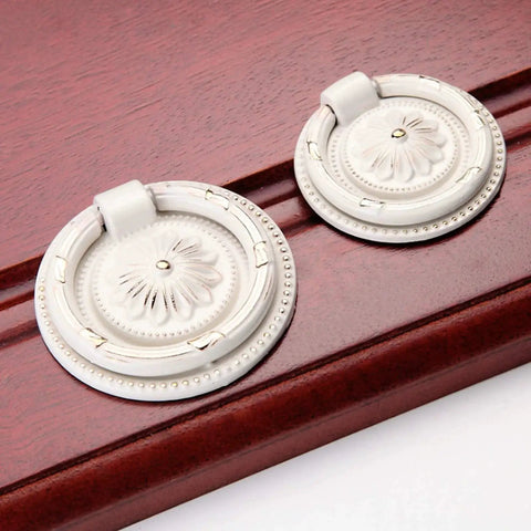 European Style Drop Ring Pull Handles for Cabinets and Drawers Lotus Pattern Knobs 2.2 Inch Diameter Zinc Alloy on wood surface