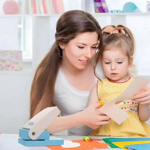 Mother and child using Portable Oval Tab Punch For Scrapbooking And Card Making with paper and craft supplies on a table.