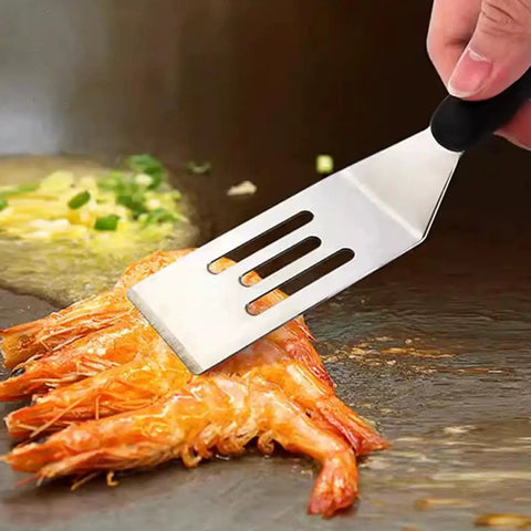 Two Piece Mini Spatula Set In Stainless Steel, Handy Metal Spatulas For Cooking And Serving, Perfect For Pancakes, Eggs, Brownies, Cookies, Desserts And Small Pans, Heat Resistant Non Slip Handle showing a slotted spatula lifting cooked shrimp.