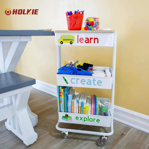 White storage cart on 3 inch swivel caster wheels with no brake, used for organizing educational supplies, shown in a home setting.