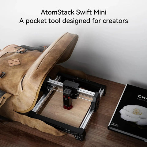 Compact Atomstack Swift Laser Engraver 3W Desktop Cutter with 135x145mm work area inside a bag, showcasing portability and design flexibility.