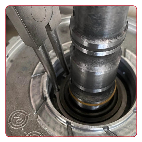 External Circlip Pliers removing ring from bearing assembly, showing close-up of heavy-duty bearing fixes with ergonomic handle.