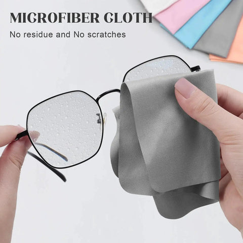 Cleaning glasses with a gray microfiber cloth from the 30 Pack Microfiber Cloths For Glasses And Electronics With 2 Lens Sprays.