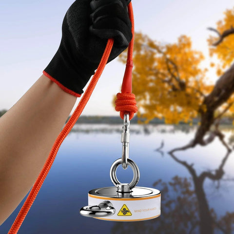 Double Sided Magnetic Fishing Kit With Beast 2600 Lb Pull, 100 Ft Rope in hand near a lake with autumn trees