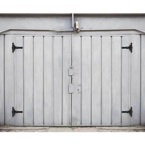 2 Pack 8 Inch T Strap Shed Door Hinges Black Tee Hinge fitted on a gray barn door, showing heavy-duty solid steel construction.