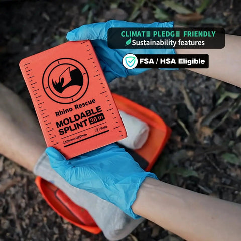 Emergency First Aid Splint For Fracture Stabilization Field Ready 36 Inch By 4.3 Inch Orange Gray in use outdoors with gloved hands