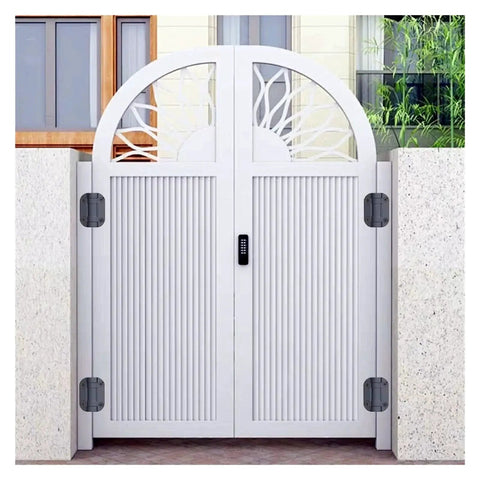Two white metal gate hinges mounted on a decorative arch gate, front view