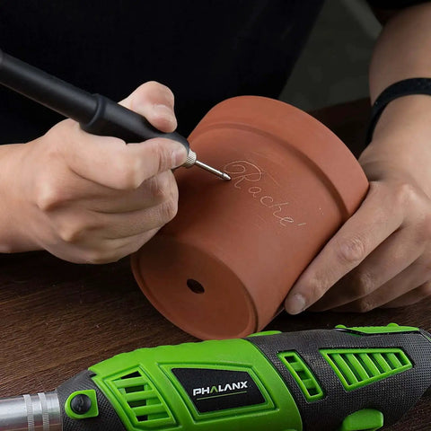 Person engraving clay pot using a Powerful 180W Rotary Tool Kit With Flex Shaft Six Variable Speeds From 8000 To 32000 RPM 139 Piece Accessories Set