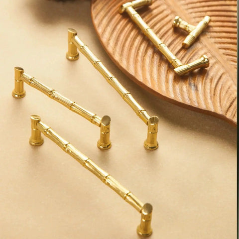 Gold Brass Bamboo Shape Cabinet Handles Set with Antique Brushed Copper Finish shown on a wooden tray, includes screws.