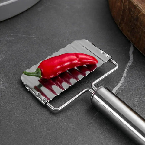 Two Pack Stainless Steel Ripple Potato Slicer And Crinkle Cutter For French Fries And Veggie Cutting Kitchen Gadget For Home And Restaurant Use With Easy Grip Handle And Pro Grade Durable Metal Construction showing serrated blade with red chili