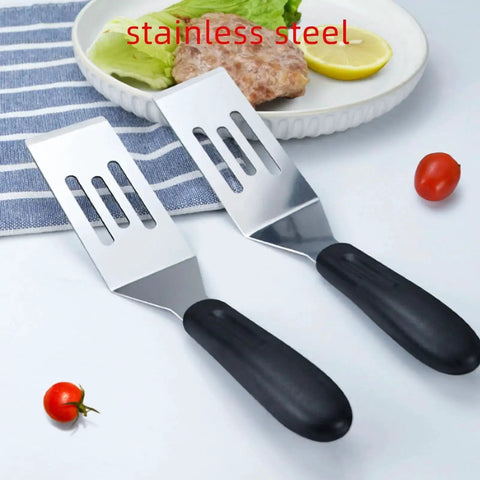 Two Piece Small Metal Spatula Set For Kitchen Use Stainless Steel Slotted And Solid Mini Spatulas For Flipping Serving And Turning Pancakes Eggs Brownies Cookies Cakes And Desserts Durable Stainless Kitchen Tools on blue cloth with food in background.