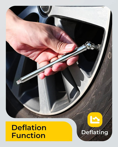 Pencil tire pressure gauge with stainless steel body being used on a car tire valve; deflation function.