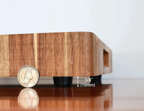Side view of a wooden cutting board elevated by Non Slip Rubber Feet For Cutting Boards With Stainless Screws 12 Pack, showing height.