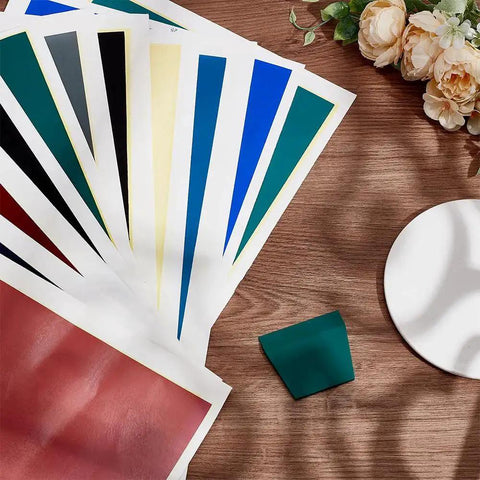 12 Color Laser Engraving Marking Paper Set With Scraper For Fiber Marking And Engraving On Metal Ceramics And Glass, Each Sheet 39 X 27 Cm on a table