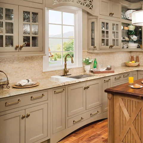 Kitchen with Antique Brass Cabinet Knob Set Six Pack Vintage Bronze Drawer Pulls on cream cabinets and wooden island.