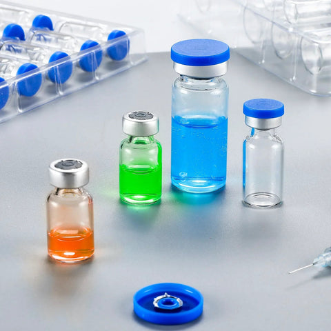 Glass 10ml sterile vials with self-healing injection port and blue caps; four vials with colored liquids.