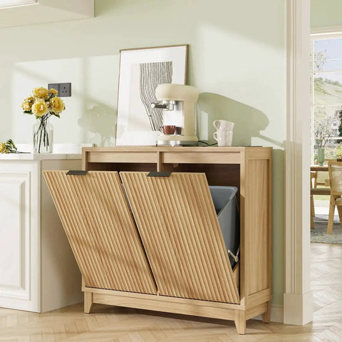 Fluted double tilt out trash can cabinet with odor control and built-in outlets in a modern kitchen setting, showing soft-close doors.