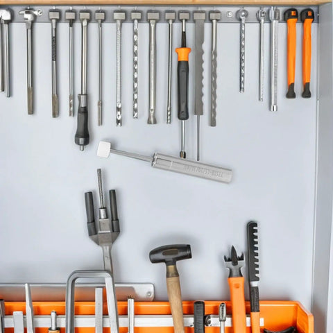 Assorted hand tools including hammers and screwdrivers organized in a toolbox with a labeled hydraulic piston tool.