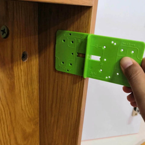 Hand using 35mm Hinge Template Router Jig For Cabinets Drawers And Furniture Doors With Pro Grade Durable Aluminum Guide And Adjustable Stops Precision Concealed Hinge Boring Jig For Woodworking Installations on wooden cabinet frame.