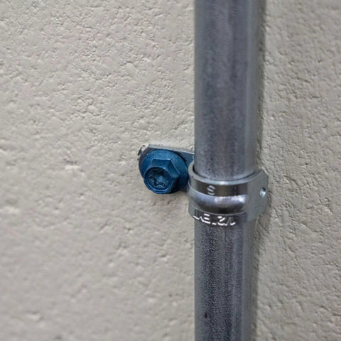 Installed Beefy Combo Pack Of Star Drive Hex Washer Head Masonry Screw with pipe, rust resistant, high strength for tough installations.