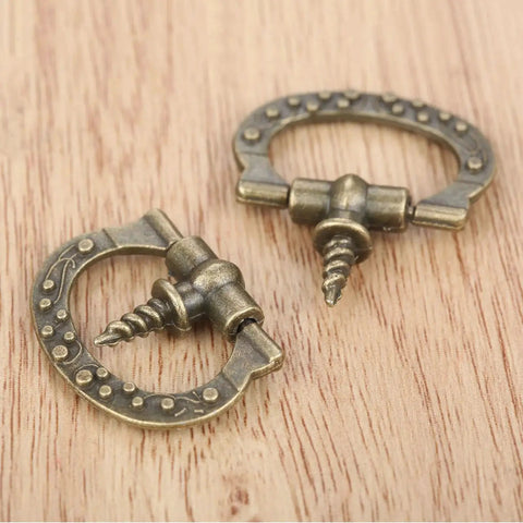Mini Cabinet Knob Set Ten Pack Antique Bronze Finish With Self Tapping Screws on wood surface, showcasing zinc alloy design.