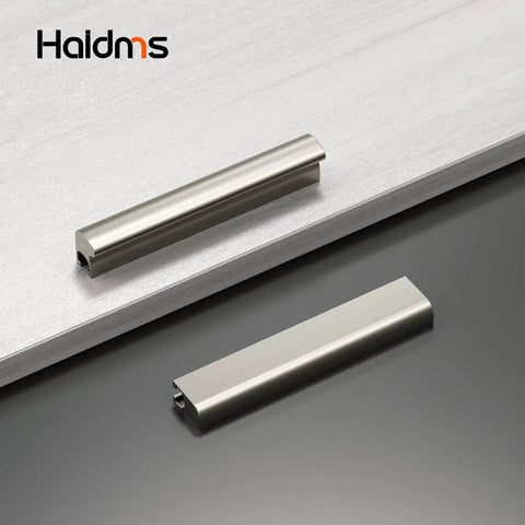 Two brushed nickel cabinet handles on a counter, part of a 10 Pack Adjustable Cabinet Handles In Brushed Nickel Square Satin Finish Drawer Pulls For Kitchen Cabinets Adjustable Hole Centers From 1 Inch To 4 Inches Center To Center From 25 Millimeters To 102 Millimeters Overall Length 4.41 Inches set.