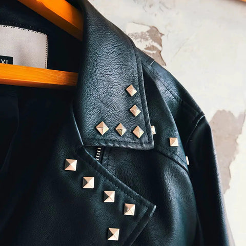 Black leather jacket with Silver Pyramid Spike Flatback Studs 200Pcs For Clothing Belts Leathercraft on collar and sleeves.