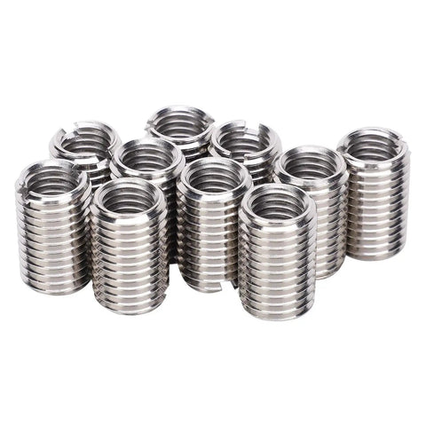 Front view of stainless steel threaded sleeve inserts for thread repair, group of small cylindrical adapters