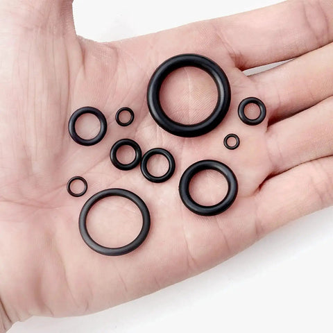 Hand holding multiple rubber O-rings from 1010 Piece Rubber O Ring Kit With 22 Sizes Universal O Ring Set For Automotive Faucets Pressure Washers Plumbing Sealing Repair Oil Gas Air Applications Heat Resistant