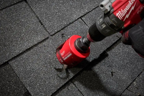 Big Hawg Four And A Quarter Inch Carbide Hole Saw Delivers Fast Clean Holes In Wood And Soft Metal With Durable Carbide Teeth Optimized Cut Rate And Long Life For Pros And DIYers By Milwaukee in use on shingles with a drill.