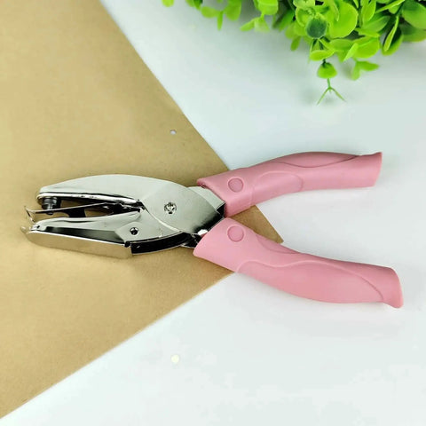 Handheld Circle Hole Punch One Ninth Inch Three Mm, pink handle, on brown paper, Single Hole Paper Punch, Easy Grip Craft And Office Tool