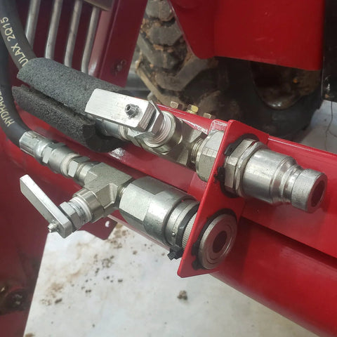 3/8 in flat-face hydraulic quick-connect couplers with dust caps on a red hydraulic assembly, ISO 16028, 3/8 NPT.
