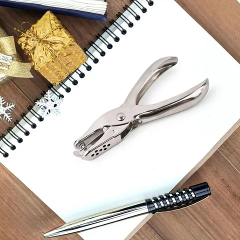 Seventeen Piece One Eighth Inch Circle Hole Punch Set for crafts on a desk with notepad and pen, durable metal construction