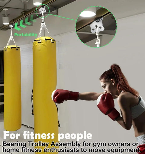 Heavy Duty Four Wheel Hoist Trolley Assembly installed in gym with boxing bag, showcasing use in warehouse and industrial settings.