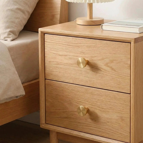 4 Pack Gold Solid Brass Round Drawer Knobs With Mounting Screws for Cabinets Dresser Kitchen and Bathroom Hardware installed on wooden drawer.