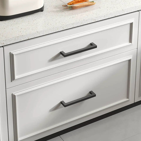 2 Pack Black Square Bar Cabinet Pulls With Slick Matte Finish installed on a white kitchen cabinet drawer