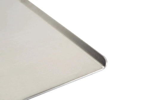 Close-up of Wear-Ever Aluminum Cookie Sheet Pan 17 by 14 Inches, showcasing the heavy gauge aluminum and smooth curved edge.