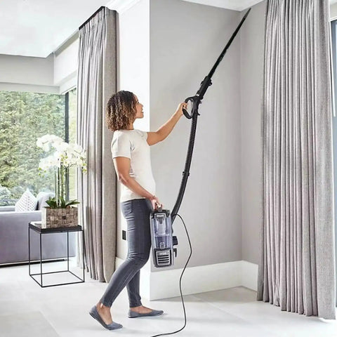 Person using Five Pack 1.25 Inch Vacuum Extension Wands With 1.38 Inch To 1.25 Inch Hose Adapter to clean ceiling corners.