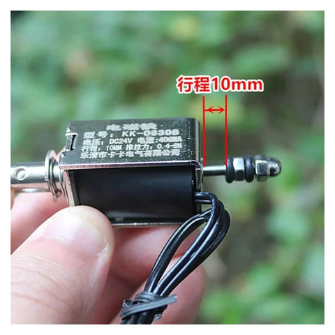 Close-up view of a DC 24V Linear Push-Pull Solenoid Electromagnet Open-Frame Spring Magnet Plunger with 10mm Stroke held in hand