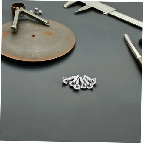 100 Piece Iron Brads With Double Leg Pins For Puppet Craft, Scrapbooking, Doll Making, shadow puppet accessories on dark surface