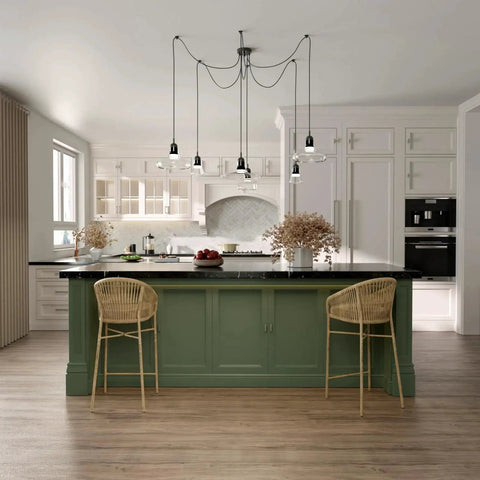 Modern kitchen with green island, wicker bar stools, hanging pendant lights, and white cabinets; neutral decor style.